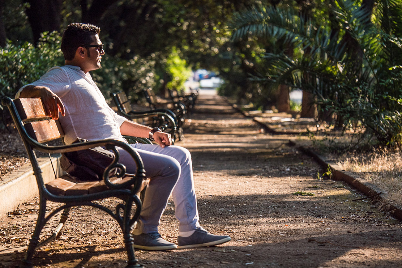 Farhad Agajani sits on a park bench, much like the one he slept on when he first arrived in Greece.