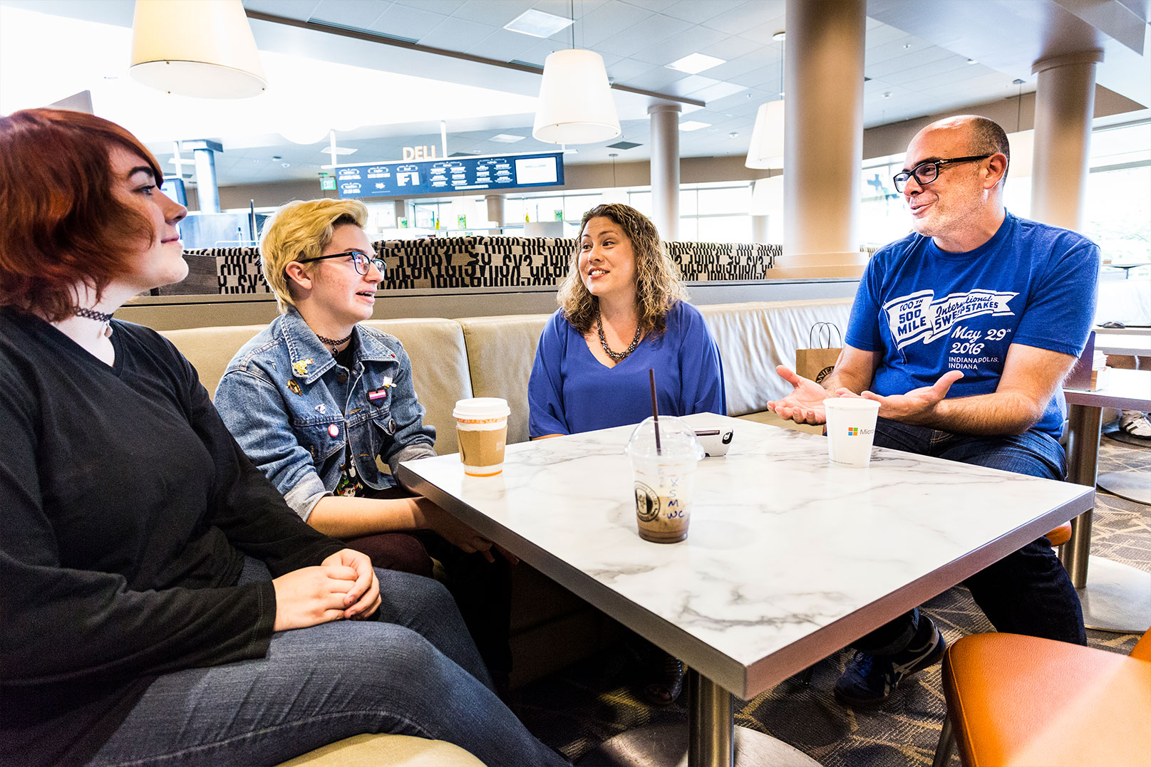 Katie and Chris Charla at a deli with their mentees