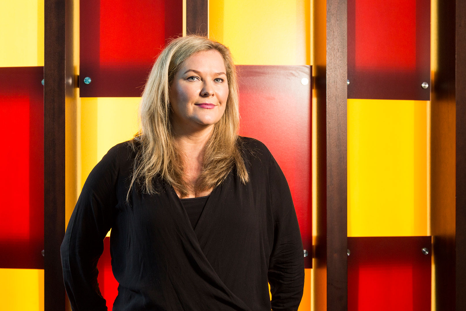 Pip standing in front of colorful wall panels