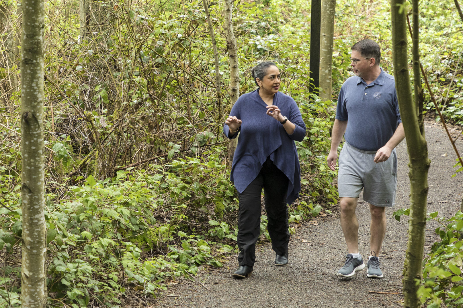 Prakriya and Sullivan walk along a woodsy trail on Microsoft’s Redmond campus.