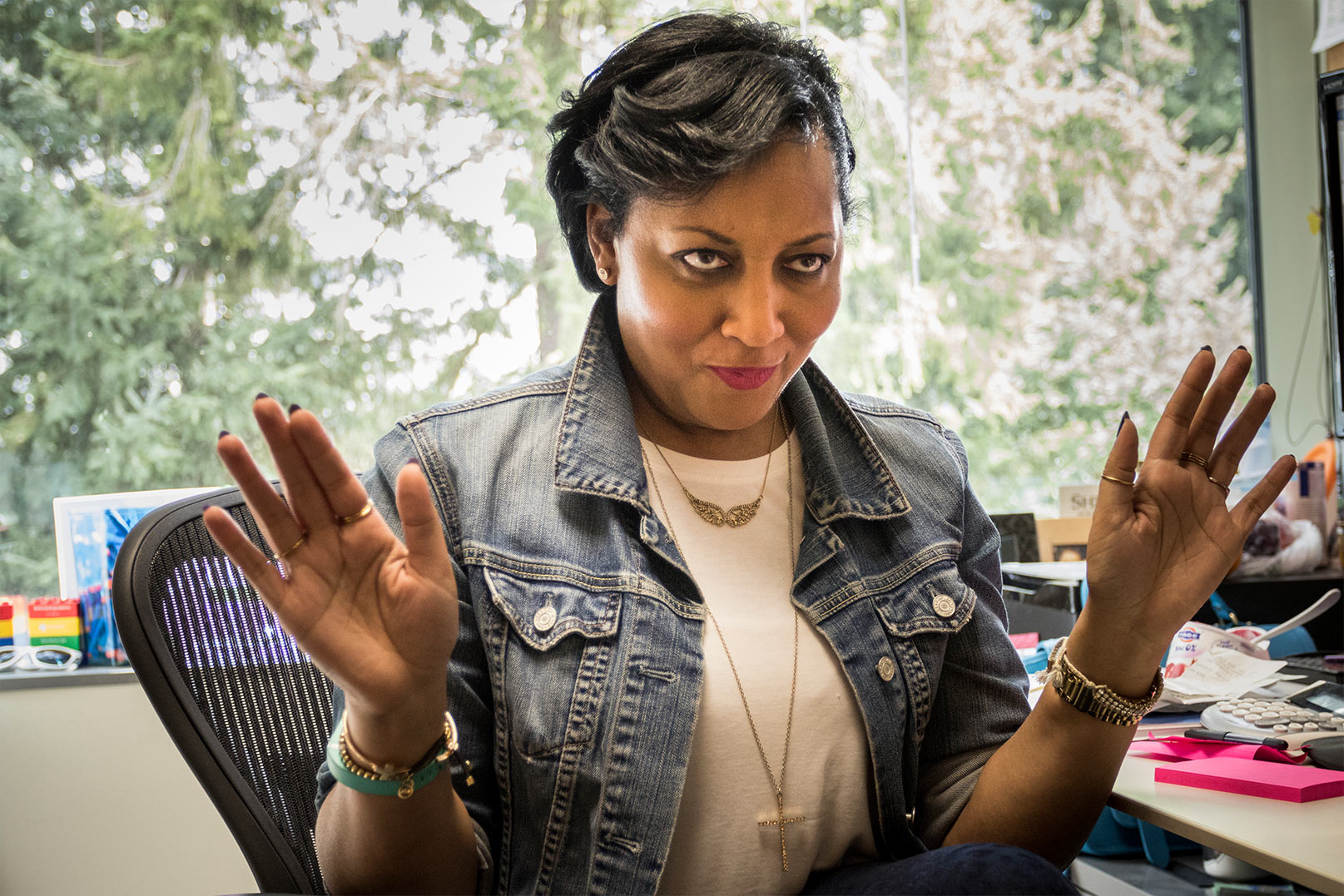 Genise with her hands up in a motion of denial